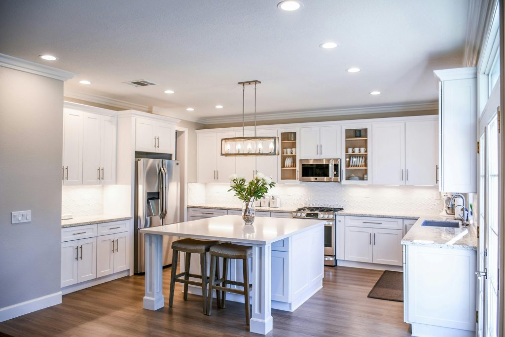 Modern and inviting bright white kitchen, showcasing sleek design and functionality, perfect for culinary enthusiasts.